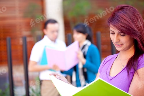 Preview: Female Student Carrying Notebooks Outdoors And Smiling