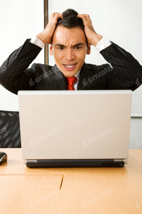 Preview: Stressed Business Man In An Office On A Laptop Computer