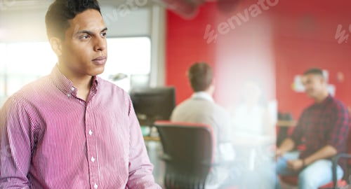 Preview: Confident Male Designer Working On A Digital Tablet In Red Creative Office Space