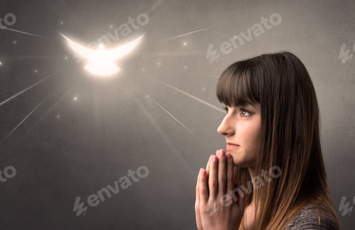 Preview: Young Woman Praying On A Grey Background With A Sparkling Bird Above Her