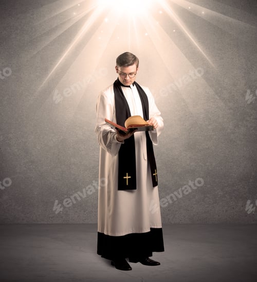 Preview: A Male Religious Young Priest In Black And White Dress Giving His Blessing, Holding The Holy Bible