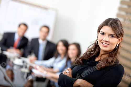 Preview: Business Woman Smiling With Her Team Behind Her