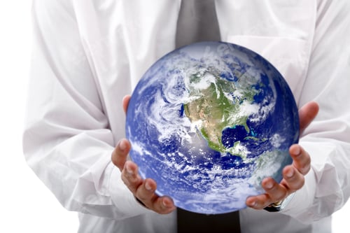 Preview: Business Woman Holding Globe Isolated Over A White Background