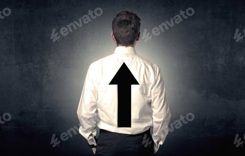 Preview: Young Businessman Standing And Thinking About Which Direction To Choose