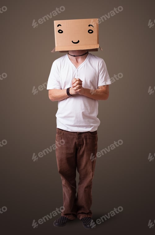 Preview: Young Man Standing And Gesturing With A Cardboard Box On His Head With Smiley Face