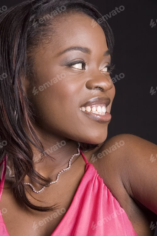 Preview: Young Black Woman Looking To One Side With A Smile