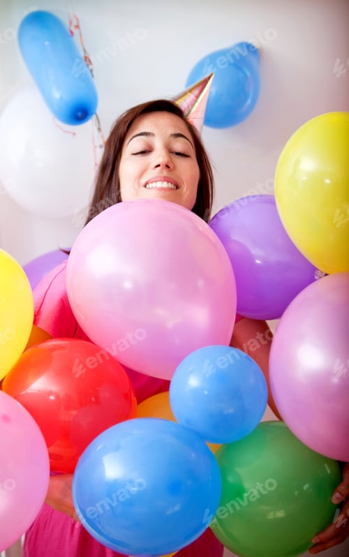 Preview: Beautiful Girl Smiling And Covered With Balloons In A Birthday Party