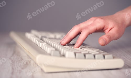 Preview: Close Up Of Hand Pressing Keyboard Buttons On Desk
