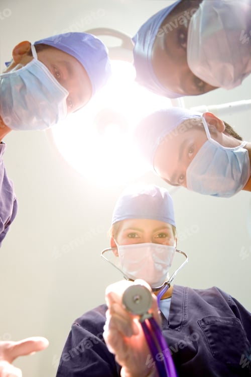 Preview: Group Of Surgeon Doctors In A Hospital Standing Under A Bright Light