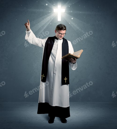 Preview: A Young Caucasian Priest With Deep Faith Blessing With The Holy Bible In His Hand In Front Of Blue