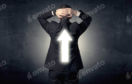 Preview: Young Businessman Standing And Thinking About Which Direction To Choose