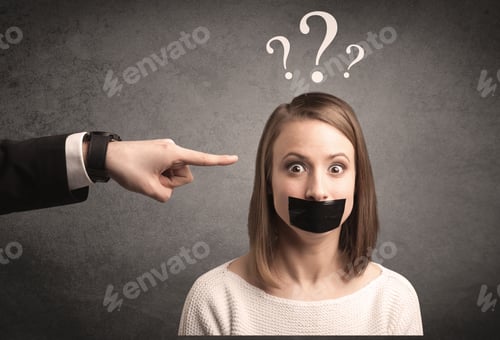 Preview: Caucasian Business Hand Pointing At Female Employee With Big White Question Mark Above Her Head