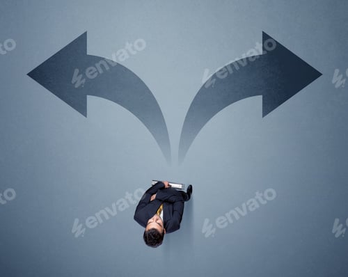 Preview: Young Smart Businessman Standing In Front Of Two Arrows Potinting To Different Ways Contemplating A