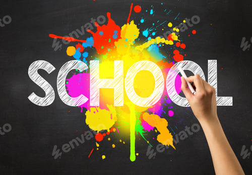 Preview: Female Hand Holding White Chalk In Front Of A Blackboard With School Written On It And A Colorful