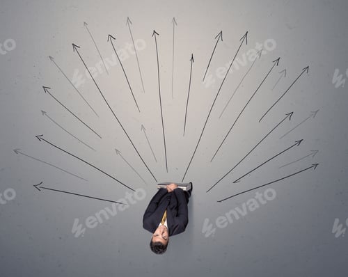 Preview: Young Contemplating Businessman Stands In Front Of Grey Arrows