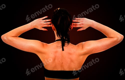 Preview: Beautiful Fit Female Back During Exercise Over A Dark Background