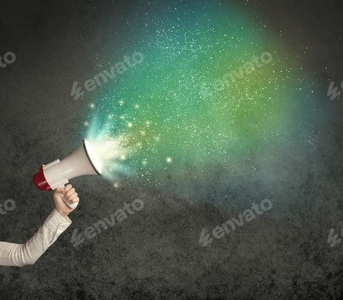 Preview: Caucasian Business Hand Holding Megaphone With White Sparkles On A Grunge Background