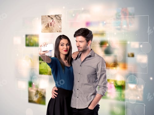 Preview: Collecting Memories Concept With Photos In Backbround And A Happy Young Couple In Love Taking