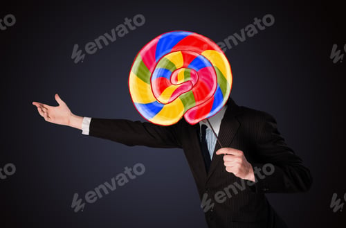 Preview: Businessman Holding A Colorful Striped Lollipop In Front Of His Head