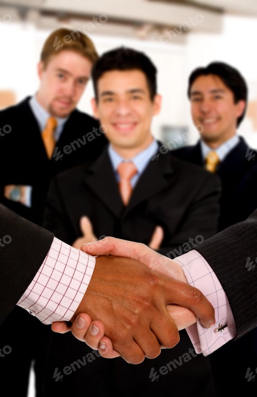 Preview: Business Deal At The Office - Team Of Businessmen Behind A Handshake