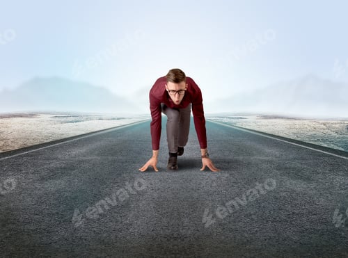Preview: Young Determined Businessman Kneeling Before Blank Running Track