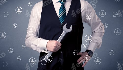 Preview: Thoughtful Businesman Holding Tool With Communication Symbols Around