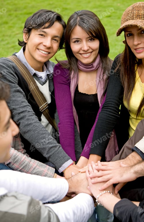 Preview: Happy Group Of Friends Smiling Outdoors In A Park With Their Hands Together