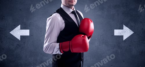 Preview: A Confident Businessman Standing With Red Boxing Gloves On His Hand In Front Of Arrows Pointing In