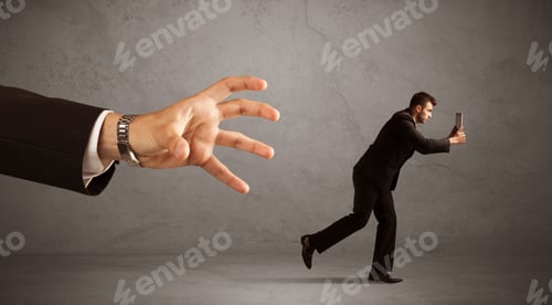 Preview: Young Miniature Businessman Running From A Big Hand With Grey Background