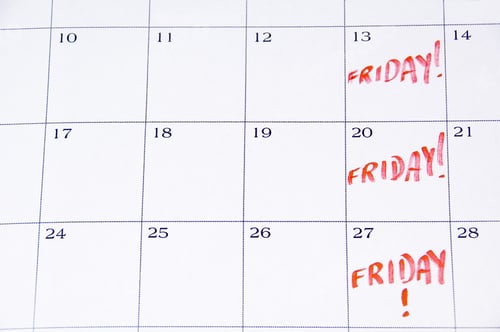 Preview: Close-Up Of White Monthly Calendar With Friday! Written In Red