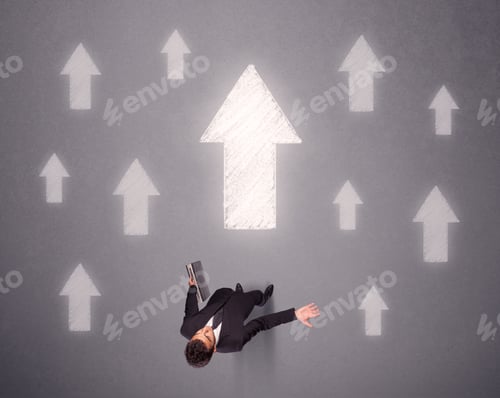 Preview: Young Contemplating Businessman Stands In Front Of White Arrows
