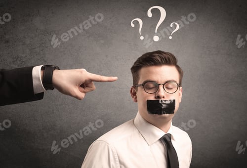 Preview: Caucasian Business Hand Pointing At Scared Employee With Big White Question Marks Above His Head