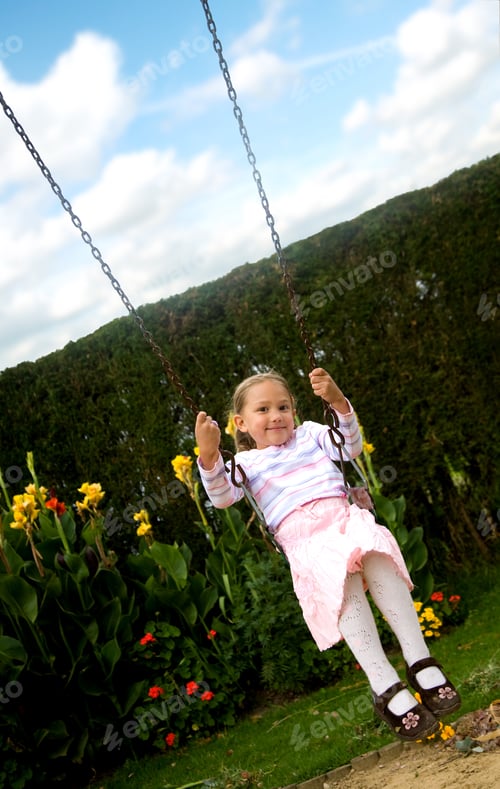 Preview: Happy Girl On A Swing In A Children Playground