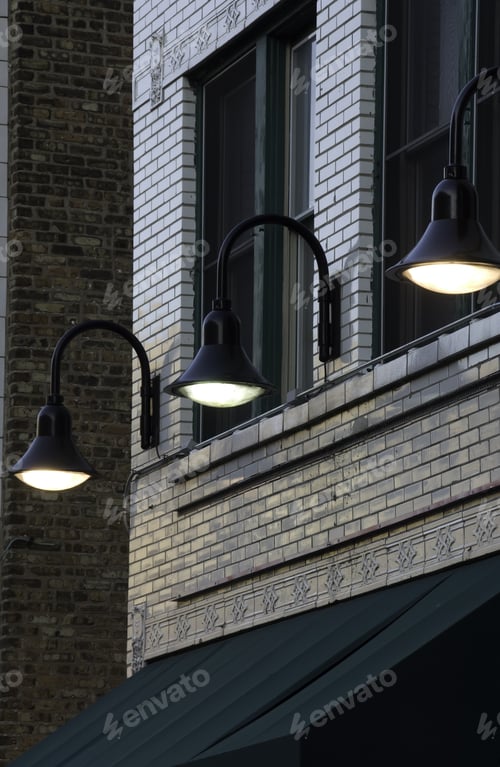Preview: Three Electric Lights Above Awning Of Storefront