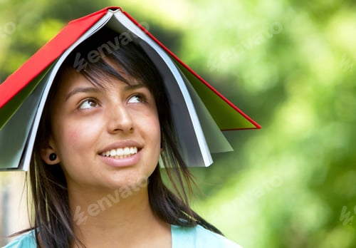 Preview: Girl With A Notebook On Her Head Outdoors