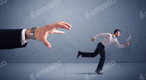 Preview: Young Miniature Businessman Running From A Big Hand With Blueish Background