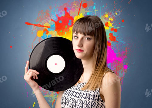 Preview: Young Lady Holding Vinyl Record On A Grey Background With Colorful Splashes Behind Her