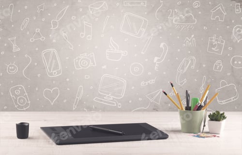 Preview: Close Up Of Business Office Desk With Laptop Tablet In Front Of Brown Wall Background Full Of Drawn