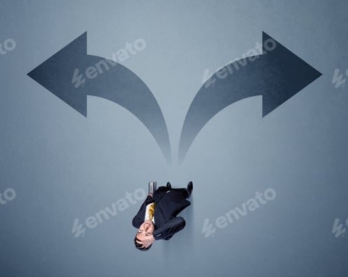Preview: Young Smart Businessman Standing In Front Of Two Arrows Potinting To Different Ways Contemplating A
