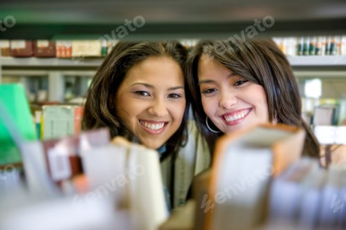 Preview: College Students In A Library Looking For A Book