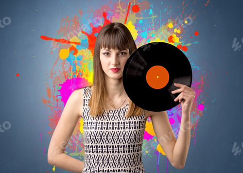 Preview: Young Lady Holding Vinyl Record On A Grey Background With Colorful Splashes Behind Her