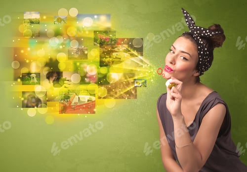 Preview: Cute Girl Blowing Colourful Glowing Memory Picture Concept On Green Background