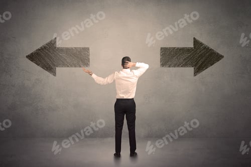 Preview: Business Man Taking A Decision While Standing In Front Of Two Grungy Arrows On Wall Concept