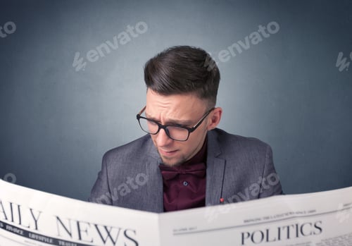 Preview: Young Smart Businessman Reading Daily Newspaper