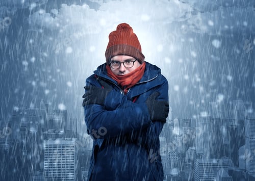 Preview: Young Man Freezing In Warm Clothing With City Concept