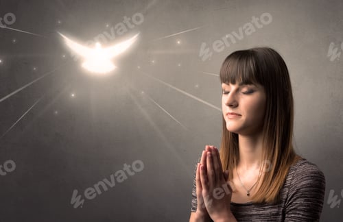 Preview: Young Woman Praying On A Grey Background With A Sparkling Bird Above Her