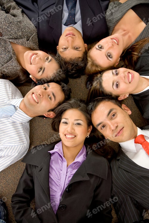 Preview: Business Teamwork In An Office With Heads Together On The Floor