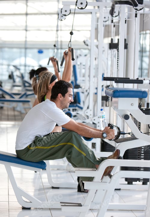 Preview: Group Of People Exercising With The Machines At The Gym