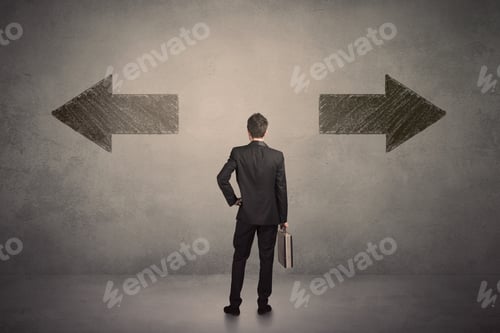 Preview: Business Man Taking A Decision While Standing In Front Of Two Grungy Arrows On Wall Concept
