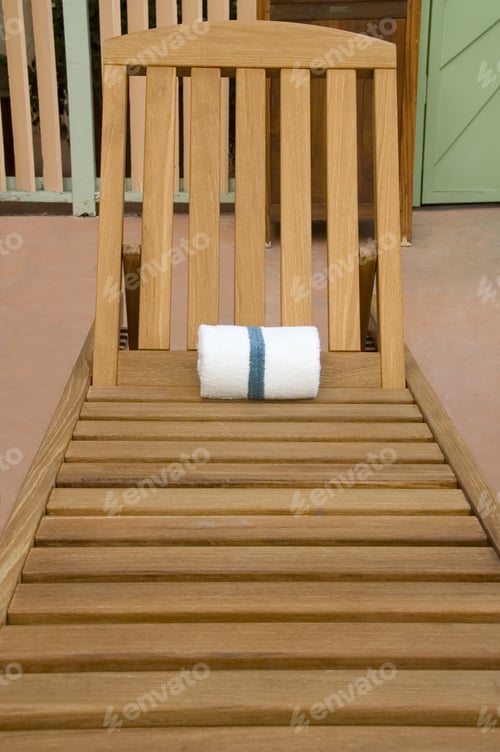 Preview: Wooden Recliner With Rolled-Up White Towel For Guest Of Beach Resort